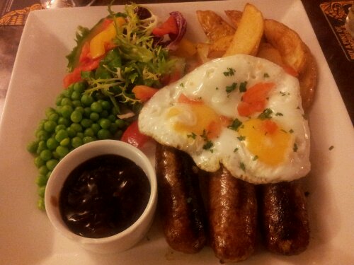 Wild boar and apple sausages, brace of eggs, chips and homemade onion ketchup