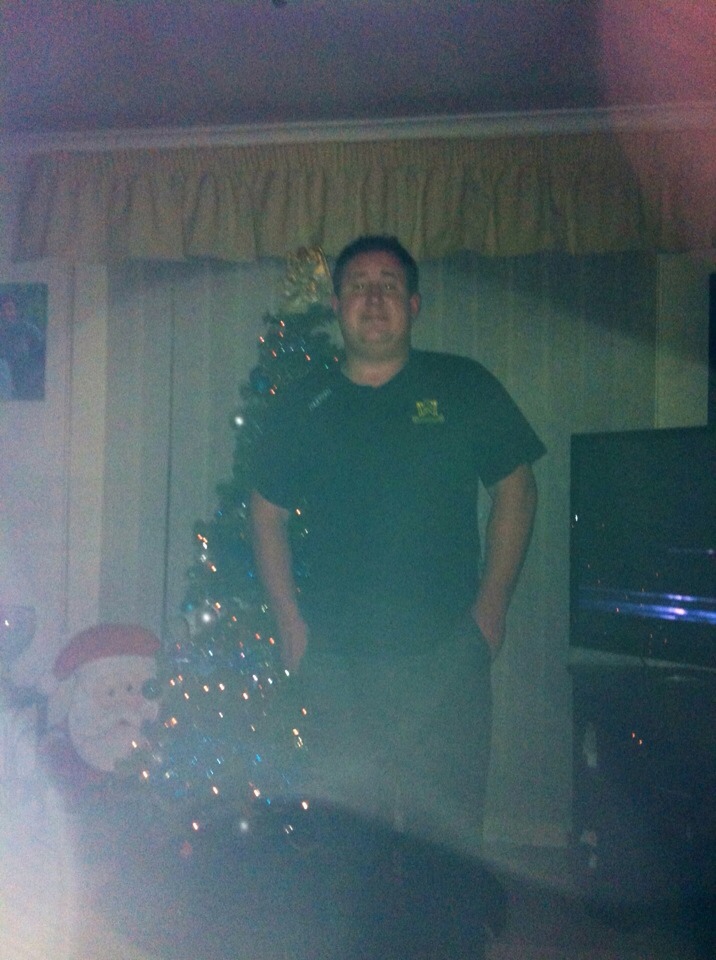 Matthew in front of their tree