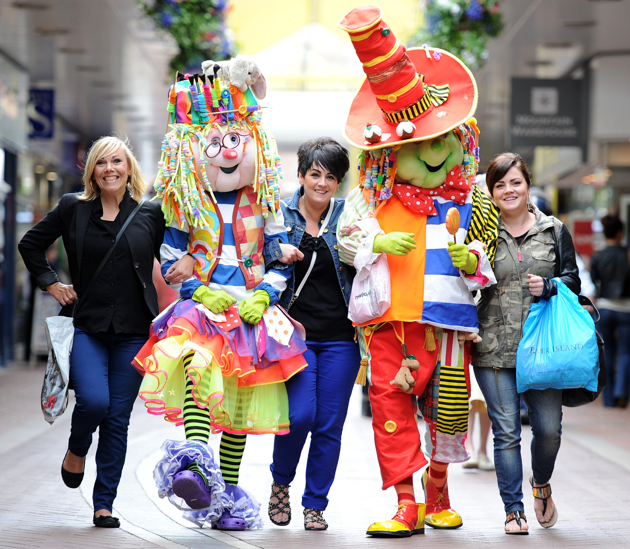 The event mascots with shoppers (l to r) Carolyn Martin, Celestina Ames and Layla Setterlund