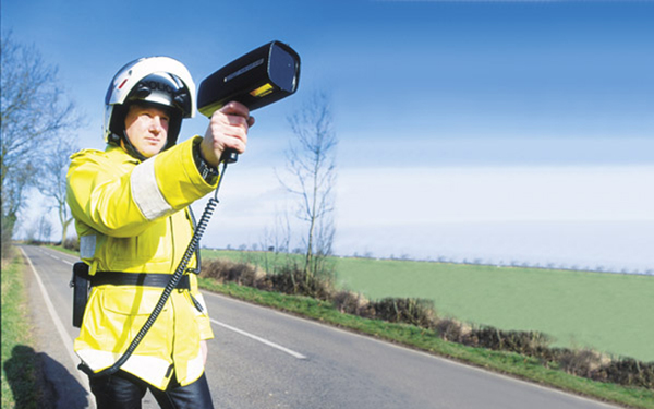 Police officer with speed camera