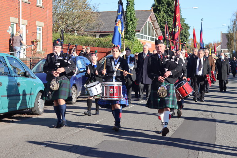 Bagpipers and a drummer lead a parade