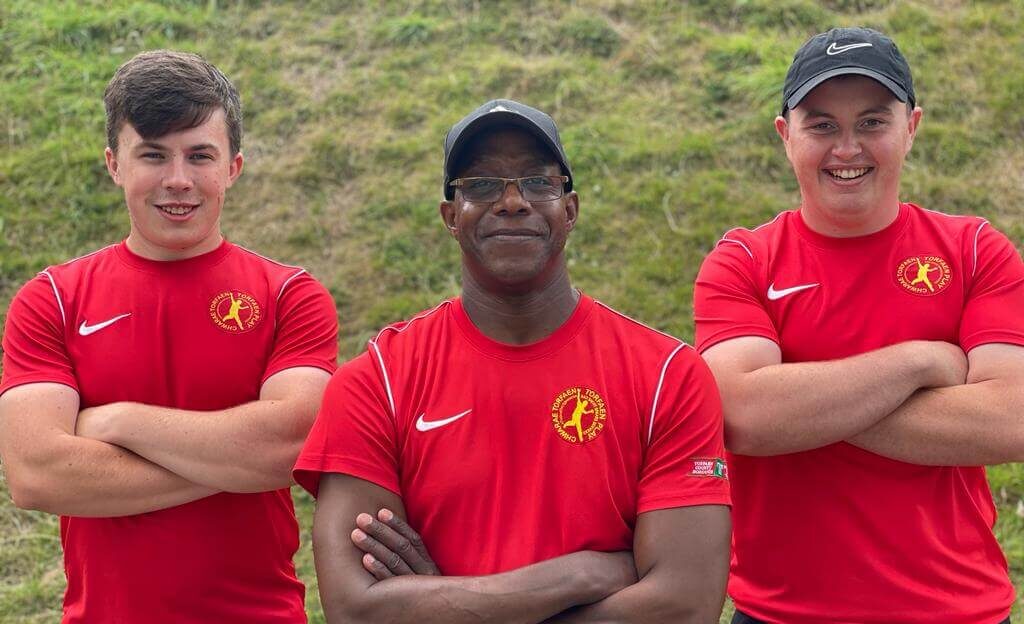 three men in red t shirts