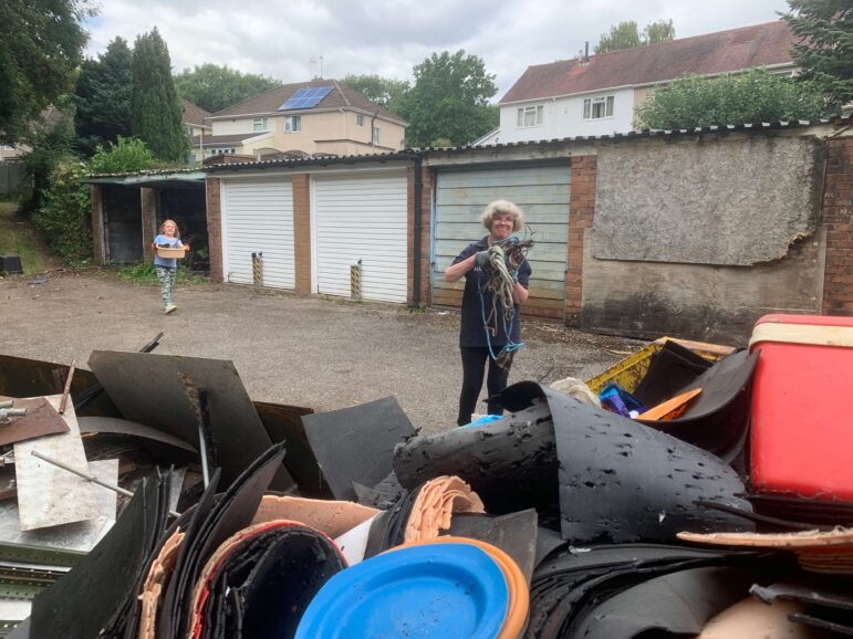 a woman putting things in skip