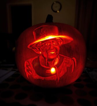 a pumpkin carved with image of the queen