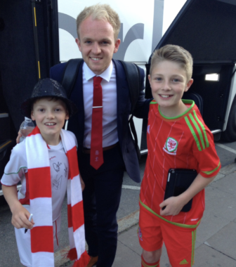 Jonny Williams with two Welsh football fans
