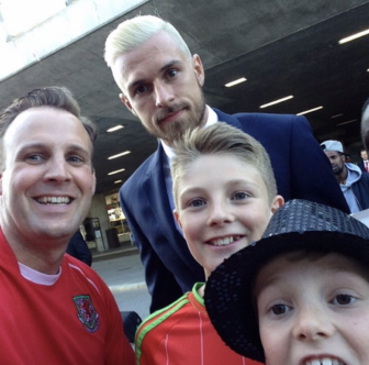 Aaron Ramsey with three Welsh fans