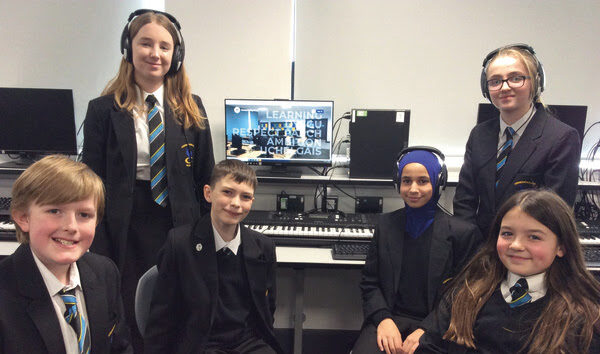 a group of school pupils in a recording studio