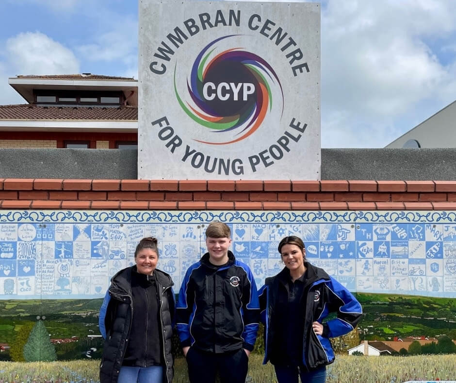three people outside a youth centre