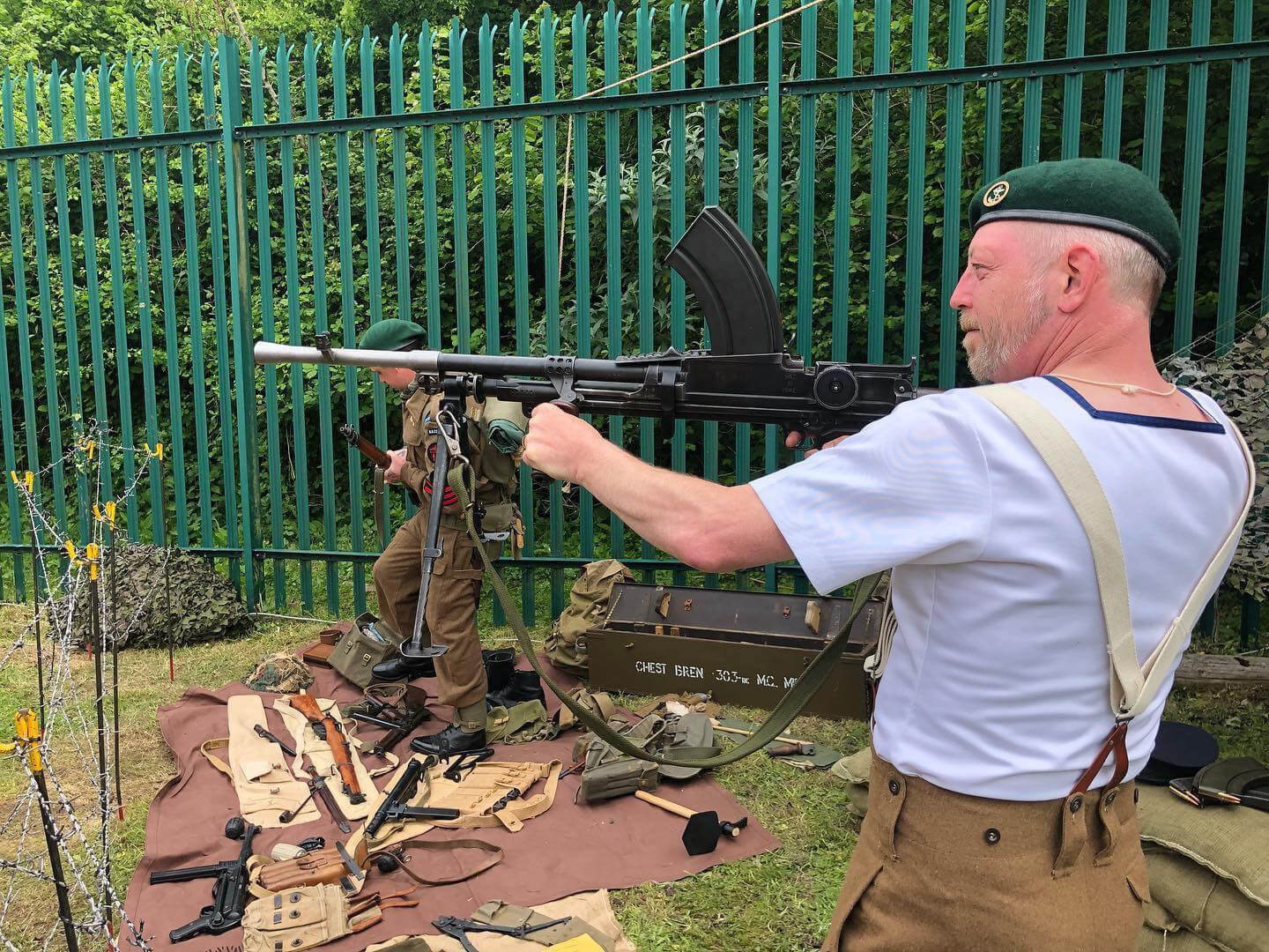 a man in a military reenactment group holds gun