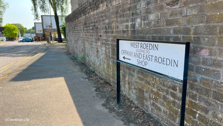 a street sign for West Roed in Cwmbran