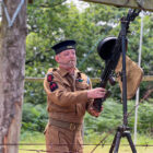 a man dressed as a soldier with a machine gun at a re-enactment event