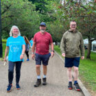 two men and a woman walking