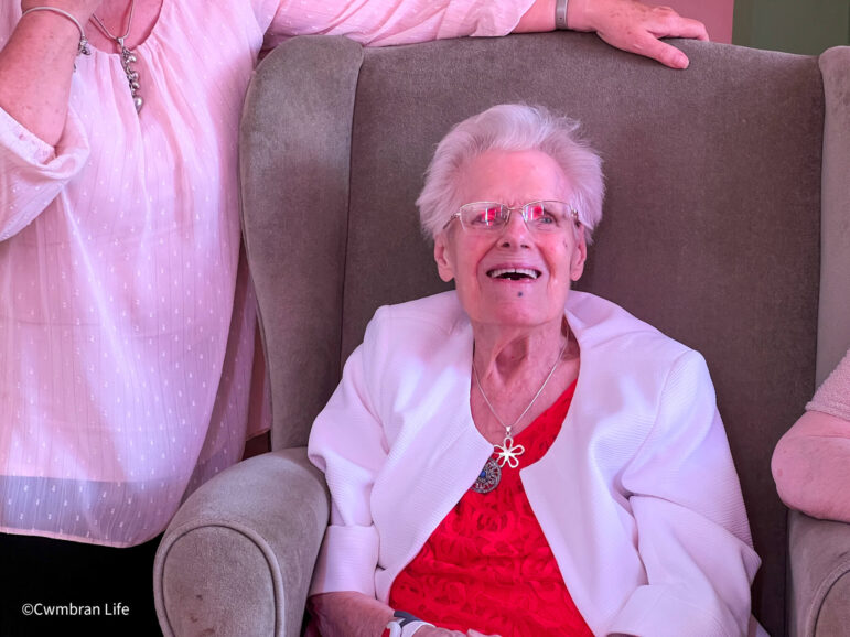 a woman smiles on her 100th birthday