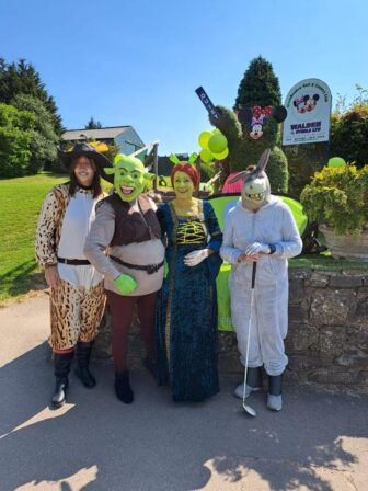 four women golfers dressed as characters from Shrek