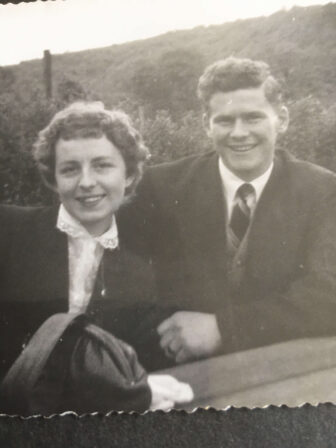 a black and white photo of a young couple