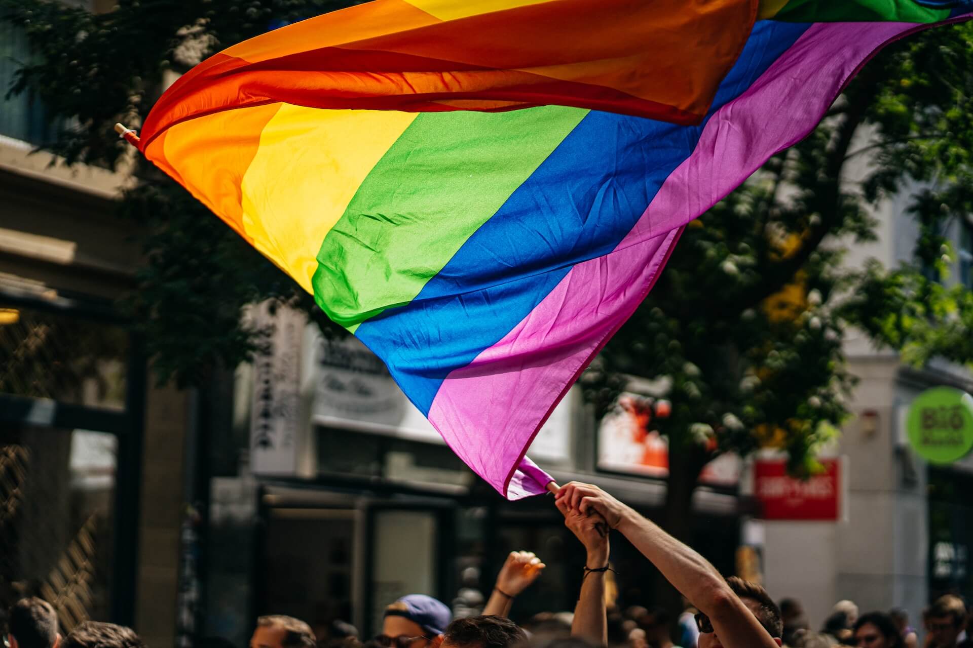 a Pride rainbow flag is waved