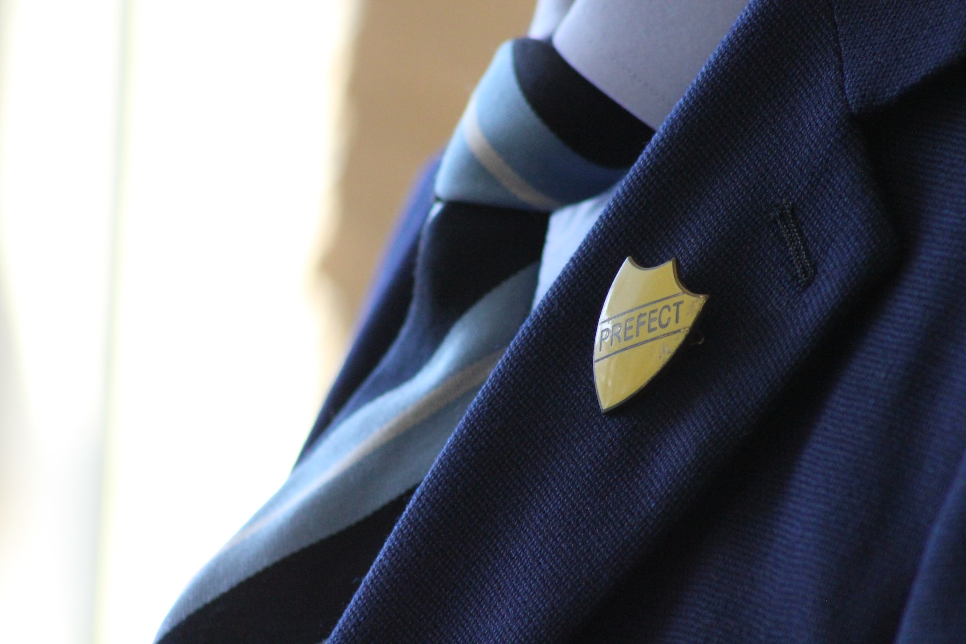 a school blazer with a prefect badge