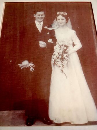 a black and white photo of a couple on their wedding day