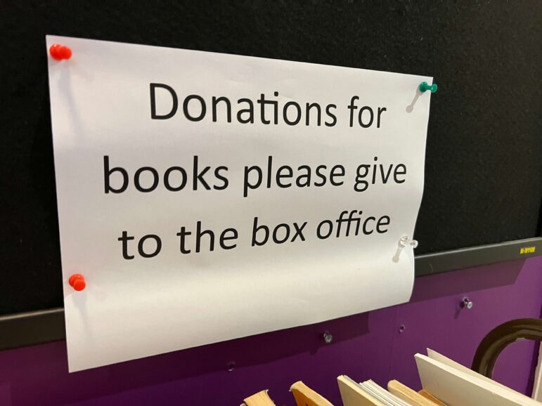 a sign about donating books to the box office