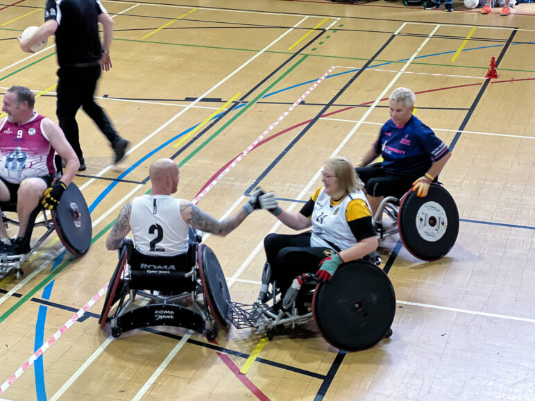 two wheelchair rugby players shake hands