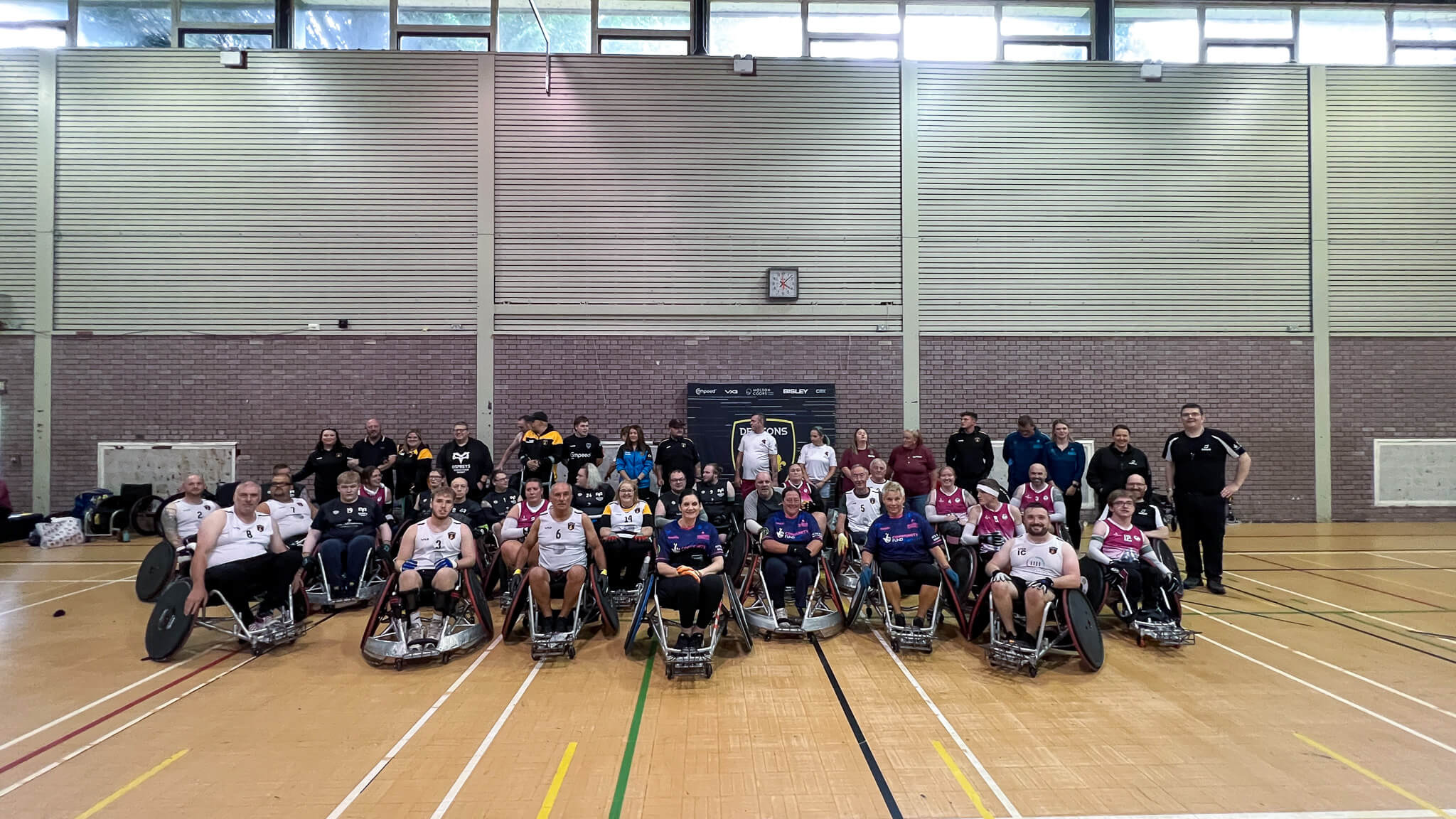 a huge group photo of wheelchair rugby players- there are about 50 in the photoi