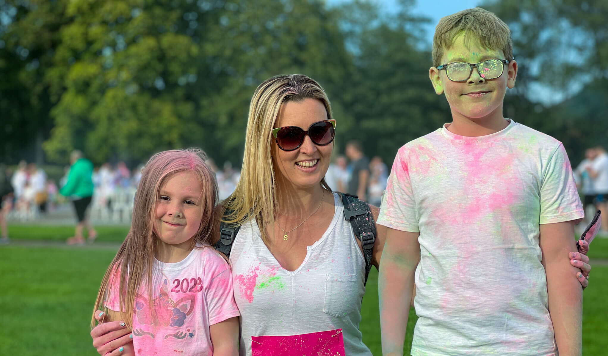 a mum and two children covered in power paint