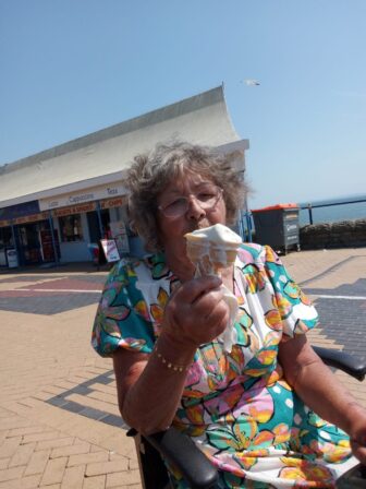 a woman holding an ice cream