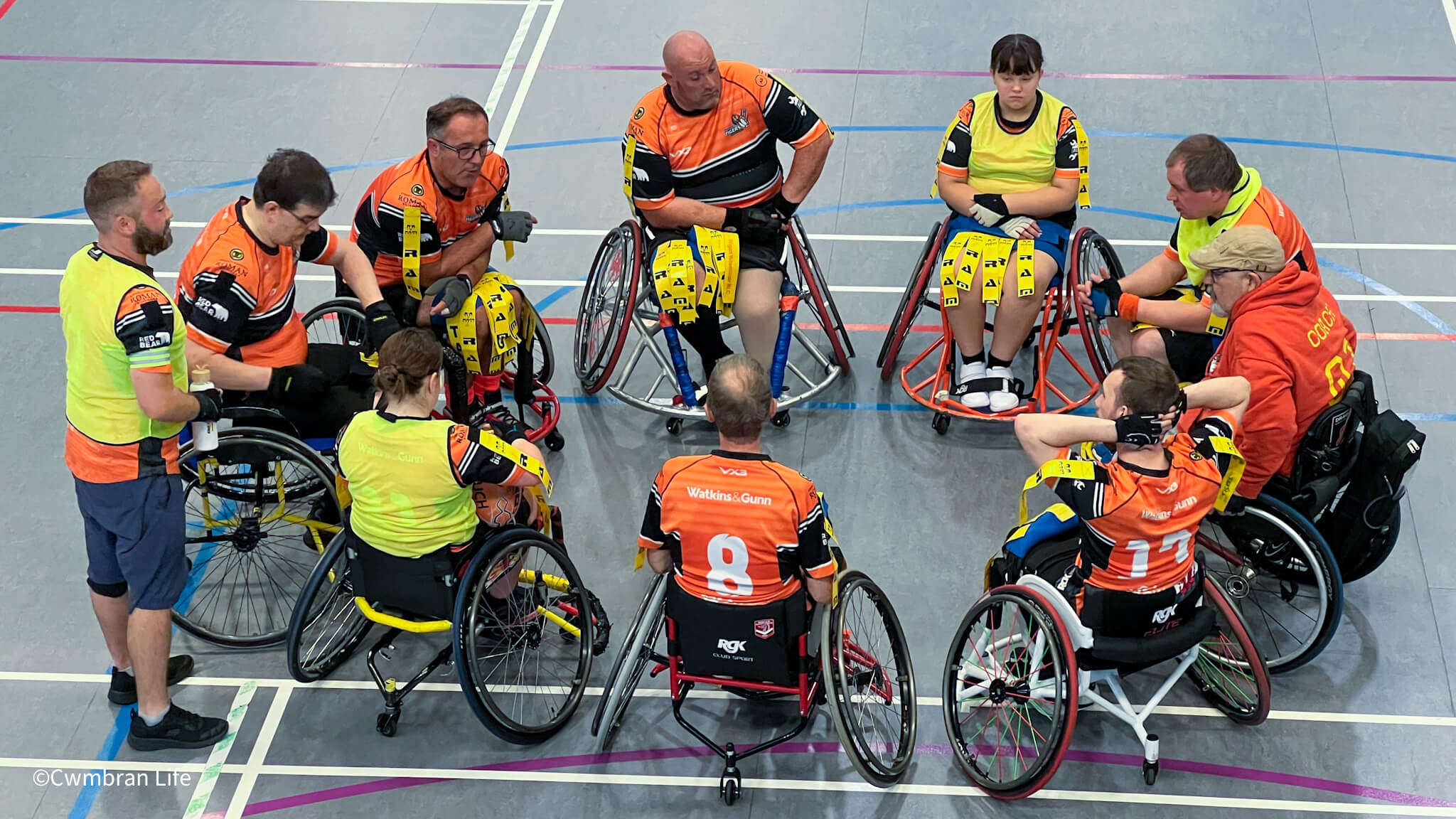 a wheelchair rugby league team have team talk