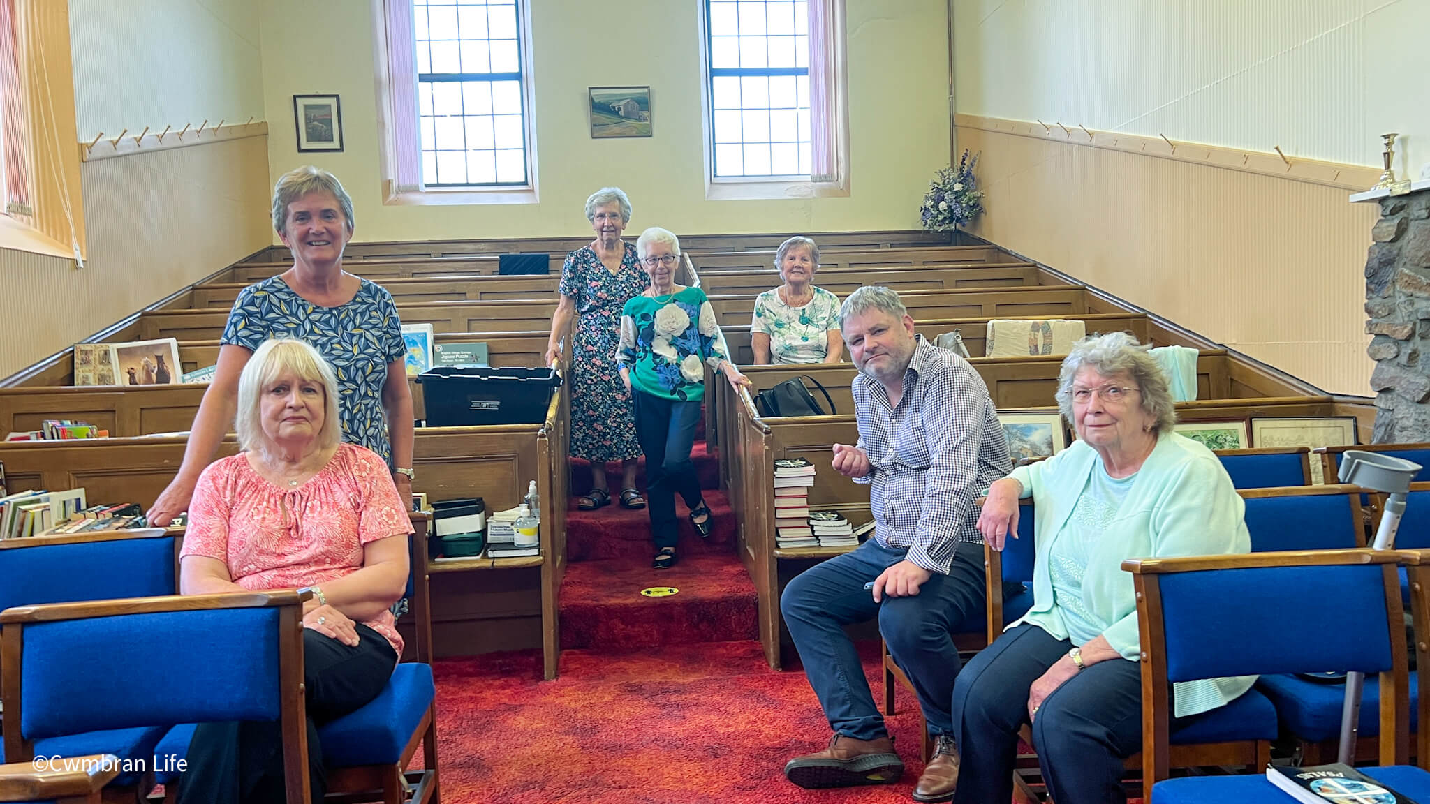 a group of people sat inside a church