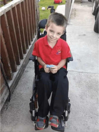 a six year old boy in a wheelchair