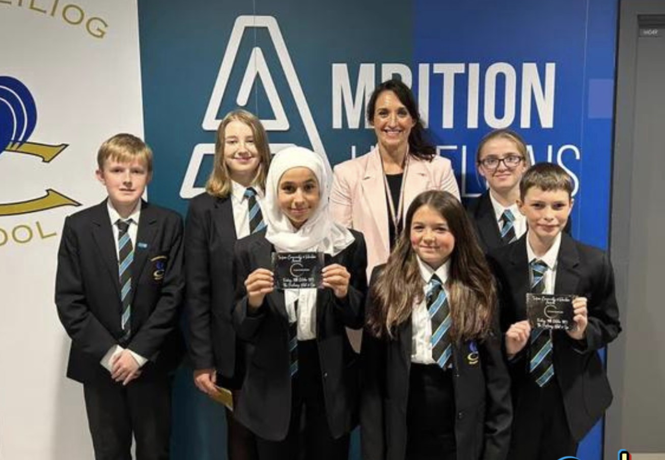 a group of pupils stood with headteacher