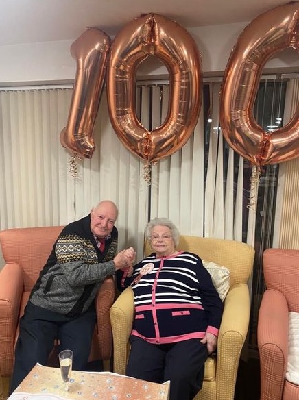 a woman celebrating her 100th birthday with familly