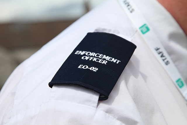 a shoulder lapel with an enforcement officer's number on it