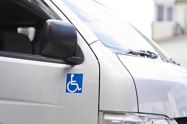a blue wheelchair sticker on a van