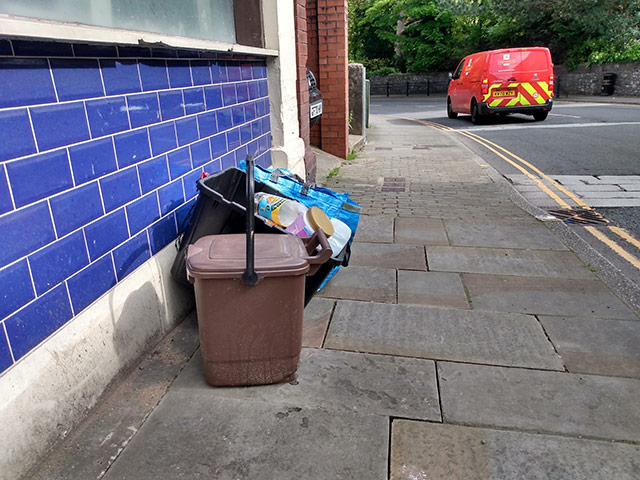 A Torfaen council issued brown food waste caddy and recycling placed on the kerbside for collection