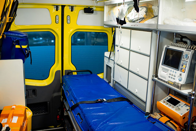 Interior of ambulance car with stretcher, refrigerator and medical equipment