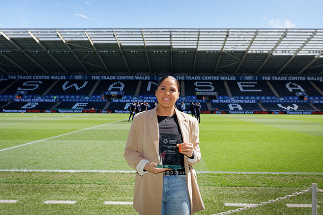 Jess Williams on the pitch at Swansea City FC with her trophy