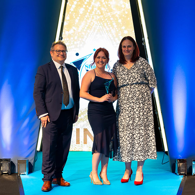 Sophie (centre) collects her Practice Supervisor of the Year award