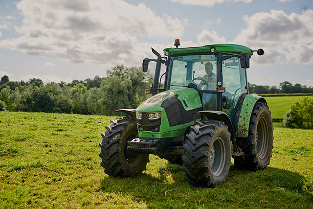man driving tractor in field