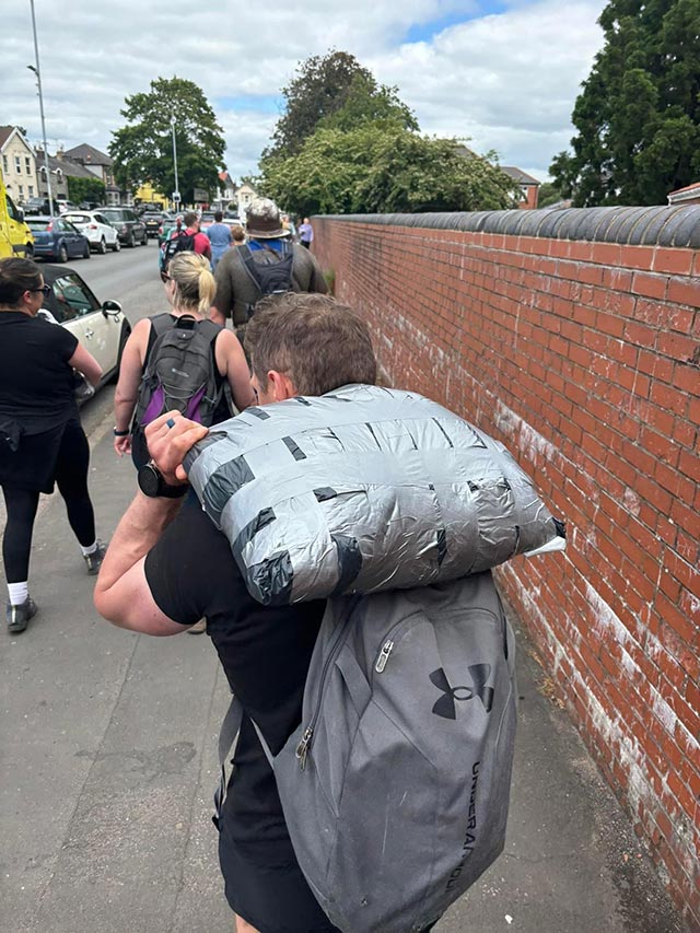 a man carries a heavy sandbag
