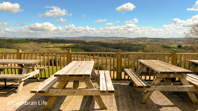 Benches outside a pub overlooking a countryside view