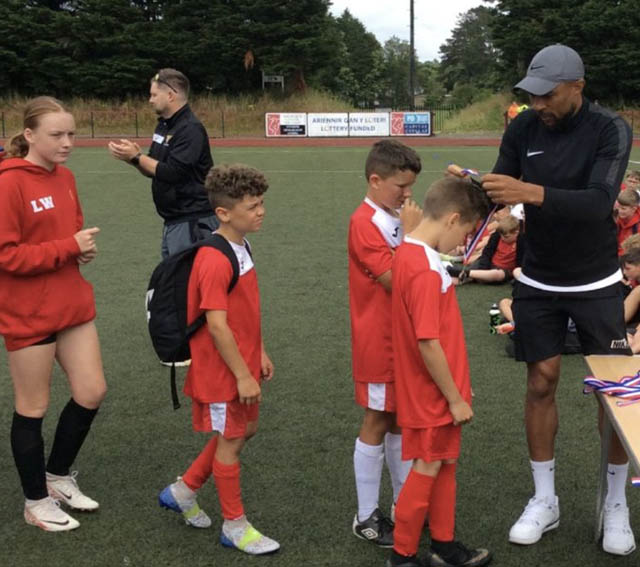 Danny Gabbidon presents medals to the two teams