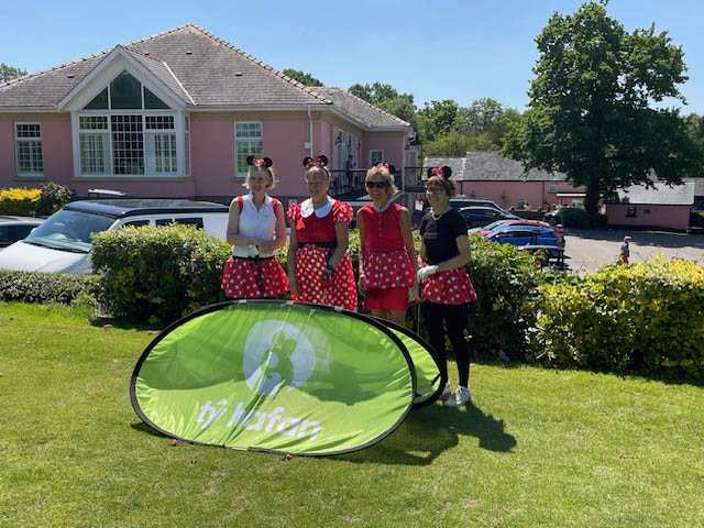 four women dressed as minnie mouse