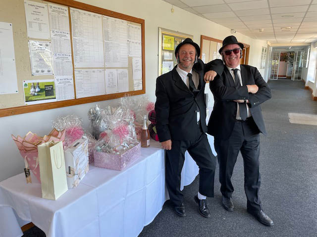 two men dressed as blues brothers