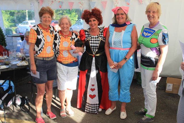 five golfers dressed in fancy dress