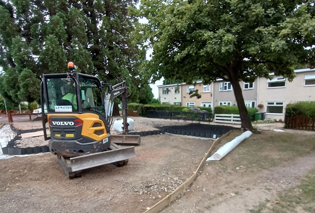 a digger next to some trees