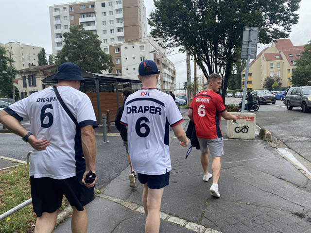 three men with 'draper' written on back of their shirts