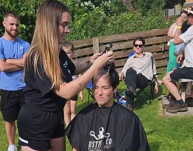 a woman having her head shaved