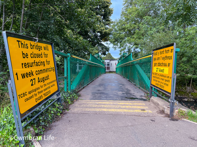 a footbridge with signs saying it'll be closed for one week