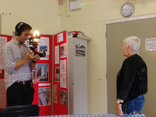 A woman being interviewed by a TV journalist